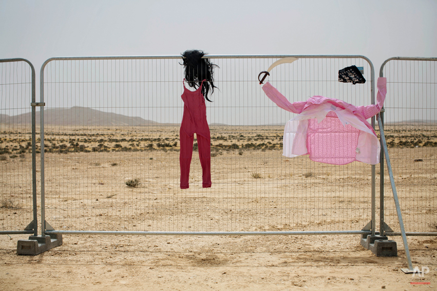 In this photo taken Wednesday, June 4, 2014, costumes hang on a fence at the first Israelís Midburn festival, modeled after the popular Burning Man festival held annually in the Black Rock Desert of Nevada, in the desert near the Israeli kibbutz of 