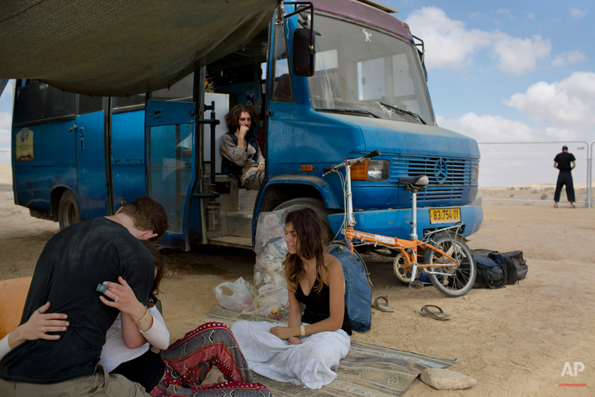  In this photo taken Saturday, June 7, 2014, Israelis sits under the shade during Israelís first Midburn festival, modeled after the popular Burning Man festival held annually in the Black Rock Desert of Nevada, in the desert near the Israeli kibbutz