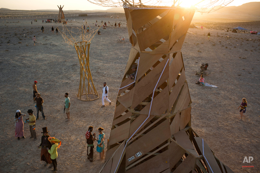  In this photo taken Friday, June 6, 2014, people, mostly Israelis, walk in the playa during Israelís first Midburn festival, modeled after the popular Burning Man festival held annually in the Black Rock Desert of Nevada, in the desert near the Isra