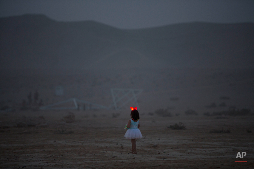  In this photo taken Wednesday, June 4, 2014, a young Israeli girl walks in the playa during Israelís first Midburn festival, modeled after the popular Burning Man festival held annually in the Black Rock Desert of Nevada, in the desert near the Isra