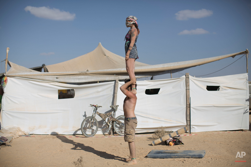  In this photo taken Friday, June 6, 2014, Israeli acrobats perform during Israelís first Midburn festival, modeled after the popular Burning Man festival held annually in the Black Rock Desert of Nevada, in the desert near the Israeli kibbutz of Sde