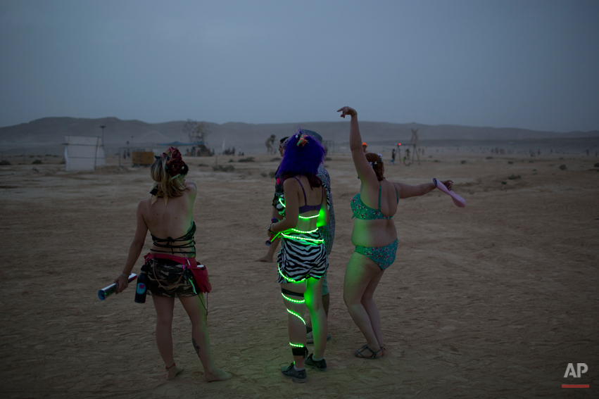  In this photo taken Wednesday, June 4, 2014, Israelis dance at a party during Israelís first Midburn festival, modeled after the popular Burning Man festival held annually in the Black Rock Desert of Nevada, in the desert near the Israeli kibbutz of