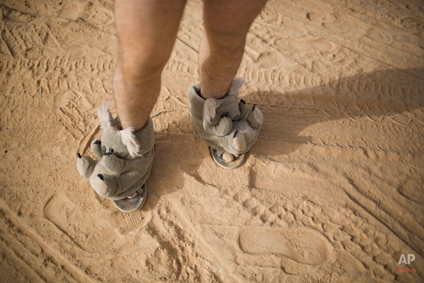  In this photo taken Thursday, June 5, 2014, an Israeli man walks in house slippers during Israelís first Midburn festival, modeled after the popular Burning Man festival held annually in the Black Rock Desert of Nevada, in the desert near the Israel