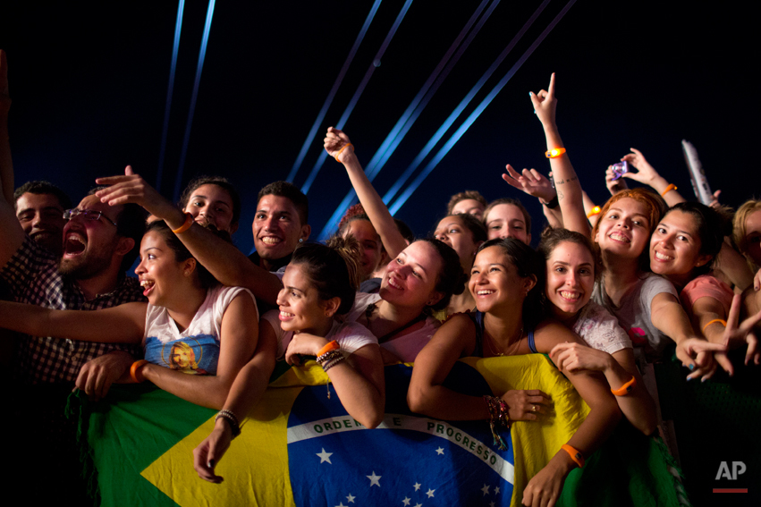  Fans watch the 'Tribute to Cazuza' show during the Rock in Rio music festival in Rio de Janeiro, Brazil, Friday, Sept. 13, 2013. (AP Photo/Felipe Dana) 