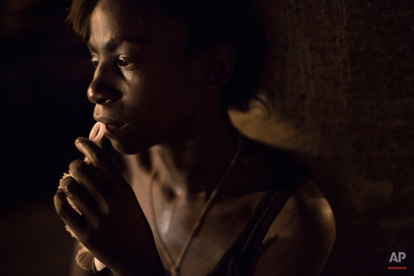  In this April 12, 2014 photo, a drug addict rests against a wall in an area known as 'crackland' at the "pacified" Jacarezinho slum in Rio de Janeiro, Brazil. After midnight, grime-covered addicts lie on the sidewalks of the Jacarezinho slum. Theyír