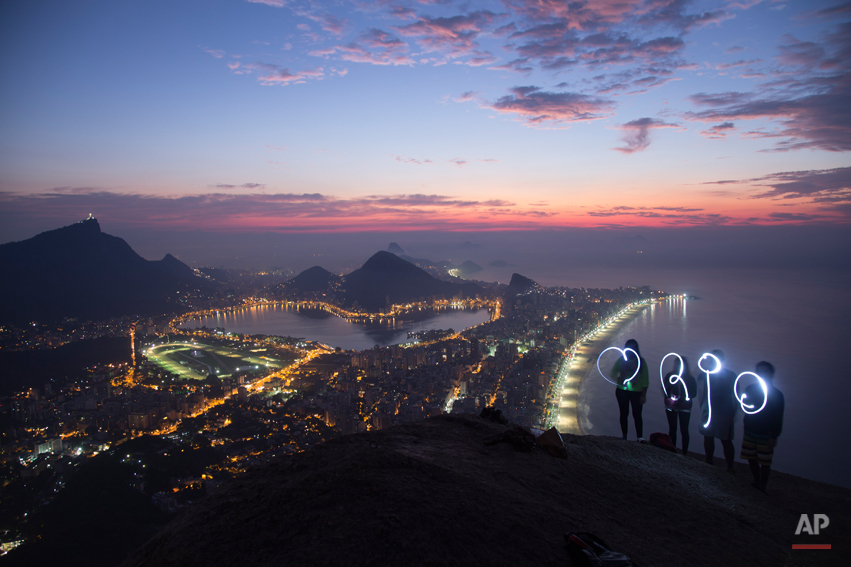  For this photo captured using a long exposure, a group of friends asked the photographer to take their picture as they used flashlights to paint with light, a heart symbol and the word 'Rio' while standing at the apex of Morro Dois Irmaos or Two Bro