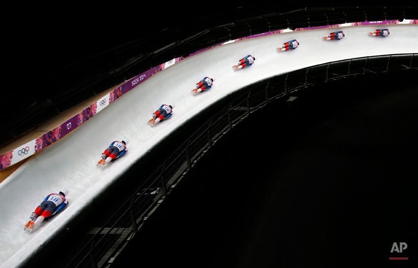  In this image made with a multiple exposure, Yun Sung-bin of South Korea speeds down the track during the men's skeleton final competition at the 2014 Winter Olympics, Saturday, Feb. 15, 2014, in Krasnaya Polyana, Russia.  (AP Photo/Felipe Dana) 