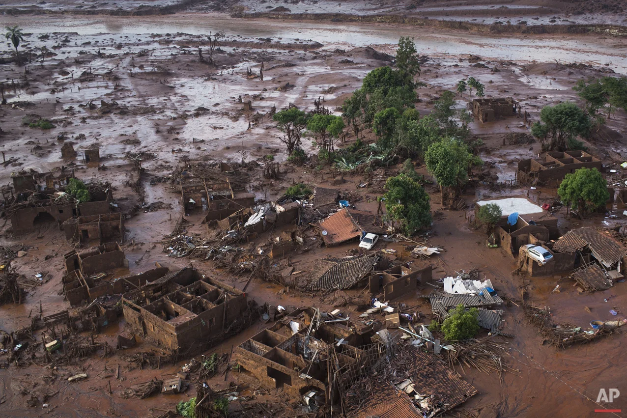 Aerial view of the debris after a dam burst on Thursday, at the small town of Bento Rodrigues in Minas Gerais state, Brazil, Friday, Nov. 6, 2015. Brazilian rescuers searched feverishly Friday for possible survivors after two dams burst at an iron ore mine in a southeastern mountainous area. (AP Photo/Felipe Dana)