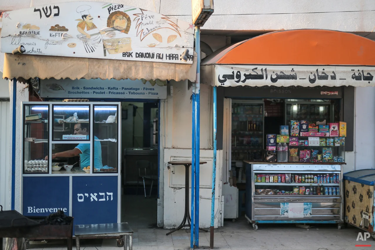 In this Thursday, Oct. 29, 2015 photo, Yona Sabbagh, 38, works in his Brik restaurant at Hara Kbira, the main Jewish neighbourhood on the Island of Djerba, southern Tunisia. The Jewish community in the resort island of Djerba traces its roots all the way back to Babylonian exile of 586 B.C., and is one of the few communities of its kind to have survived the turmoil around the creation of Israel, when more than 800,000 Jews across the Arab world either emigrated or were driven from their homes. (AP Photo/Mosa'ab Elshamy)