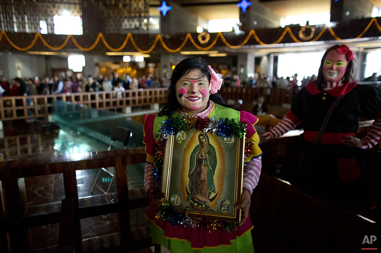 A clown holds a picture of the Virgin of Guadalupe, as she arrives for a mass at the Basilica of Our Lady of Guadalupe in Mexico City, Monday, Dec. 14, 2015. Hundreds of clowns belonging to various clown associations made their annual pilgrimage to the Basilica on Monday to pay their respects to the Virgin of Guadalupe, Mexico's patron saint. (AP Photo/Rebecca Blackwell)