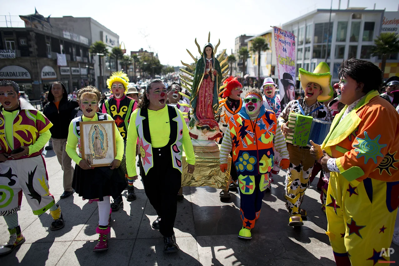 Clowns carry a statue of the Virgin of Guadalupe, as they arrive at the Basilica of Our Lady of Guadalupe in Mexico City, Monday, Dec. 14, 2015. Hundreds of clowns belonging to various clown associations made their annual pilgrimage to the Basilica on Monday to pay their respects to the Virgin of Guadalupe, Mexico's patron saint. (AP Photo/Rebecca Blackwell)