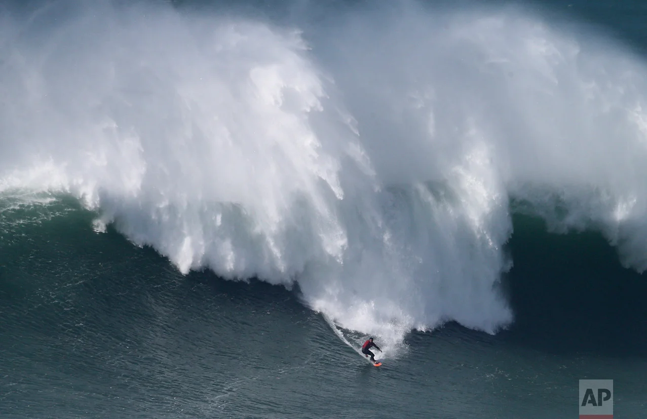 Rafael Tapia, from Chile, drops down a wave during a big wave surfing session at the Praia do Norte, or North beach, in Nazare, Portugal, Friday, Feb. 10, 2017. (AP Photo/Armando Franca)