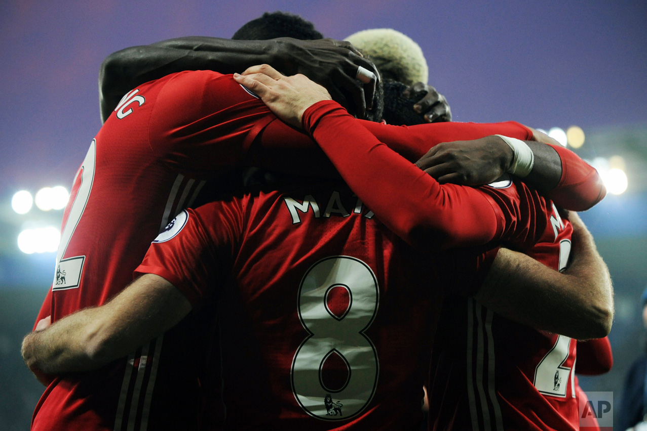 Manchester United's players celebrate after Juan Mata, center, scored the team's third goal during the English Premier League soccer match between Leicester City and Manchester United at the King Power Stadium in Leicester, England, Sunday, Feb. 5, 2017. (AP Photo/Rui Vieira)