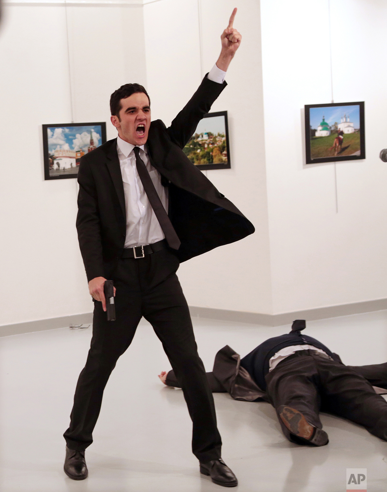 Mevlut Mert Altintas shouts after shooting Andrei Karlov, right, the Russian ambassador to Turkey, at an art gallery in Ankara, Turkey, Monday, Dec. 19, 2016. Associated Press photographer Burhan Ozbilici won the 2017 World Press Photo competition Monday Feb. 13, 2017 for the image. It was part of a series titled "An Assassination in Turkey" which also won the Spot News - Stories category, captured in the moments before and after Altintas, an off-duty policeman, drew a handgun and shot Karlov at a photo exhibition.(AP Photo/Burhan Ozbilici)