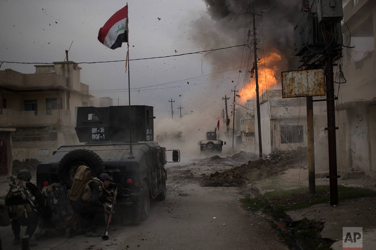 A car bomb explodes next to Iraqi special forces armored vehicles as they advance towards Islamic State held territory in Mosul, Iraq, Wednesday, Nov. 16, 2016. AP photographer, Felipe Dana, came third in the Spot News - Singles category in the 2017 World Press Photo competition for his image of an explosion in Mosul. (AP Photo/Felipe Dana)