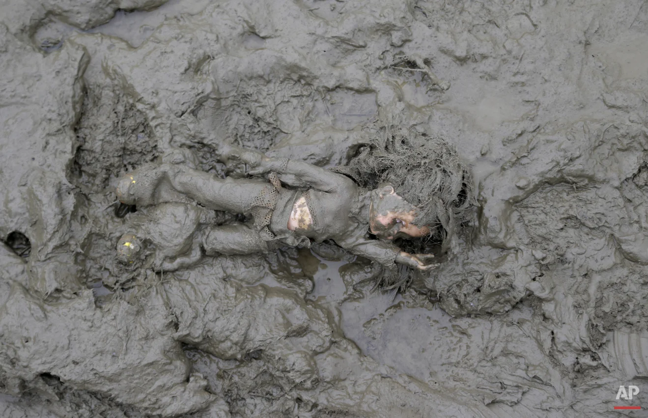 A doll lies in the mud after being left behind close the border with Croatia near the village of Zakany, Hungary, Saturday, Oct. 17, 2015. (AP Photo/Petr David Josek)