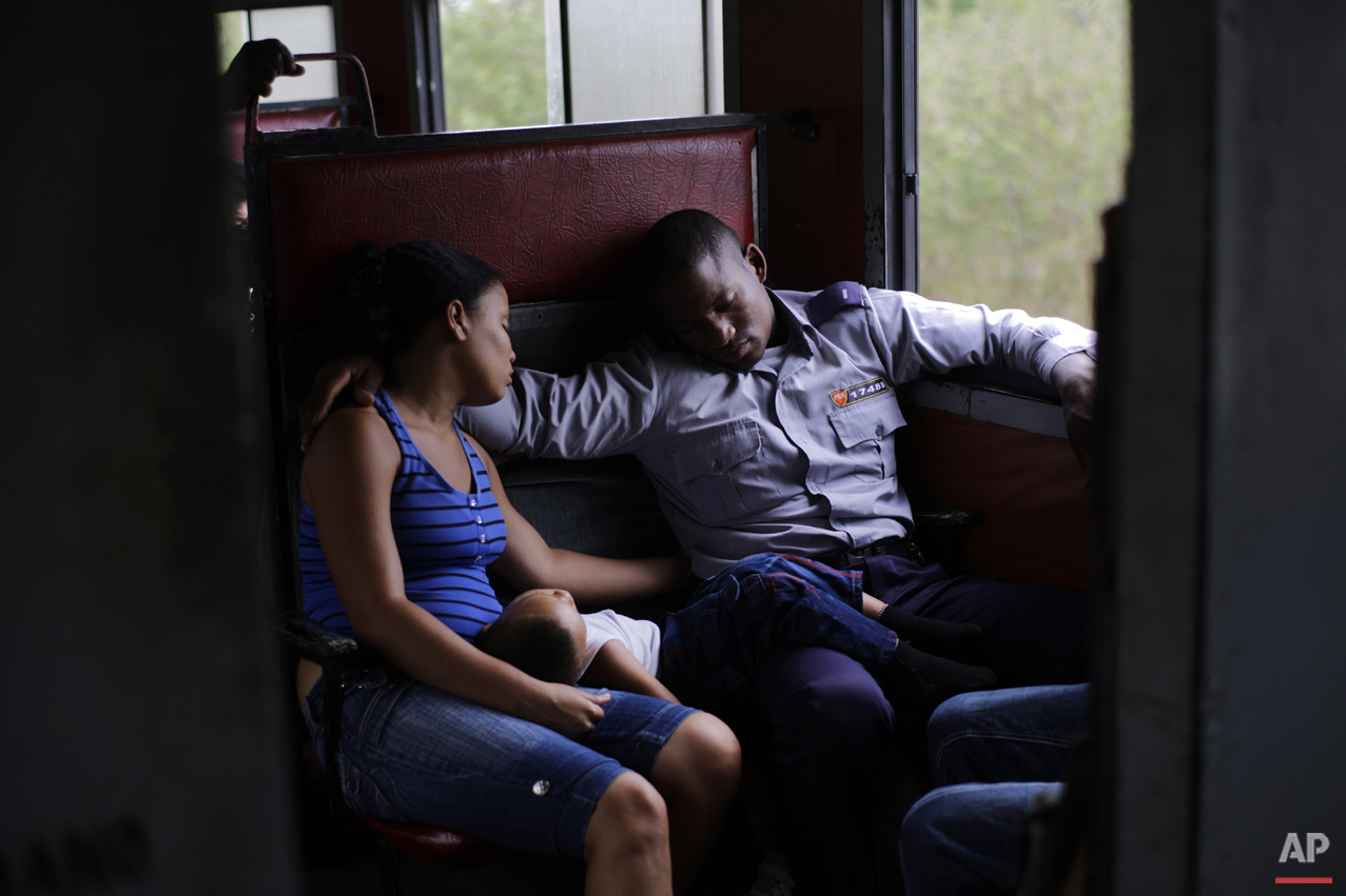  In this March 23, 2015 photo, an off-duty police officer travels with his family to Santa Clara during a long trip through the province of Holguin in Cuba. From east to the west, trains offer a fine-grained, slow-moving view of Cuba that few foreign