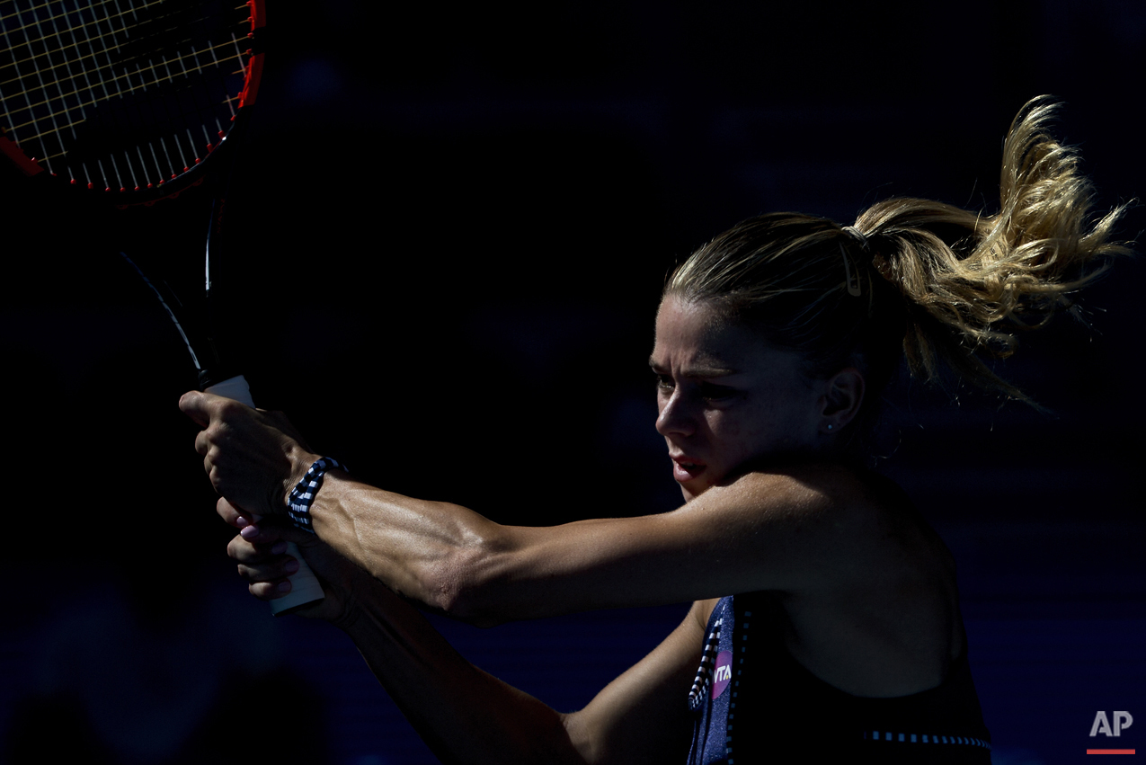  In this Saturday, Oct. 3, 2015 photo, Camila Giorgi of Italy returns a ball against Timea Bacsinszky of Switzerland during the China Open tennis tournament at the National Tennis Stadium in Beijing. (AP Photo/Andy Wong, File) 