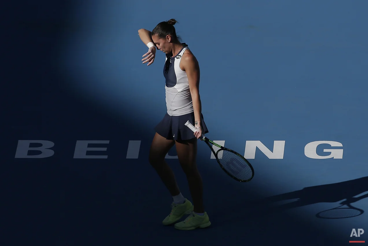 Flavia Pennetta of Italy reacts after missing a point to Anastasia Pavlyuchenkova of Russia during their women's singles match of the China Open tennis tournament at the National Tennis Stadium in Beijing, Thursday, Oct. 8, 2015. (AP Photo/Andy Wong)