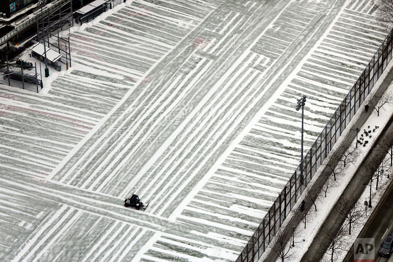  A lone plow clears a playground in lower Manhattan, photographed from New York's One World Trade Center building, Monday, Jan. 9, 2017. As the East Coast waits to thaw out from a weekend icy mess, another storm is bringing rain and the potential of 