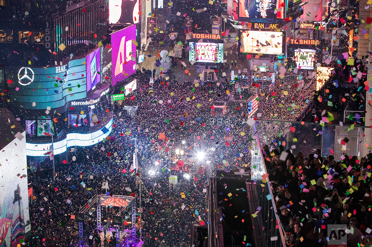  Revelers celebrate the new year as confetti flies over New York's Times Square as seen from the Marriott Marquis, Sunday, Jan. 1, 2017. (AP Photo/Mary Altaffer) 