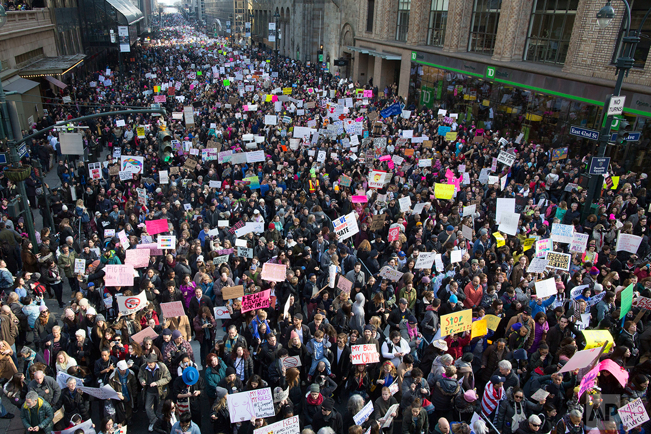  Demonstrators march across 42nd Street during a women's march, Saturday, Jan. 21, 2017, in New York. The march is being held in solidarity with similar events taking place in Washington and around the nation. (AP Photo/Mary Altaffer) 