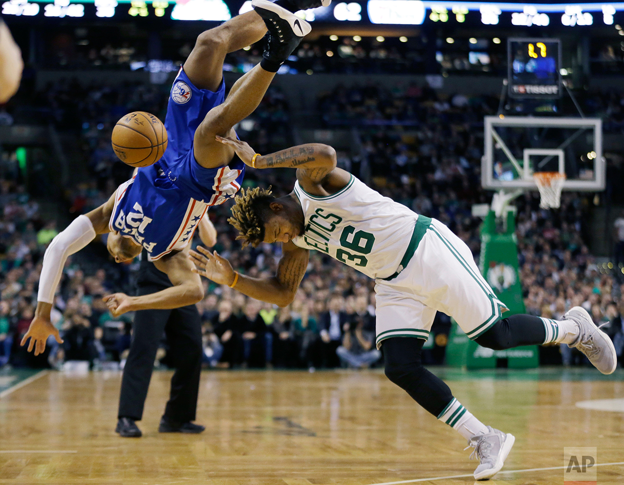  Philadelphia 76ers guard Gerald Henderson (12) falls as he tries to block a shot by Boston Celtics guard Marcus Smart (36) in the second quarter of an NBA basketball game, Friday, Jan. 6, 2017, in Boston. (AP Photo/Elise Amendola) 
