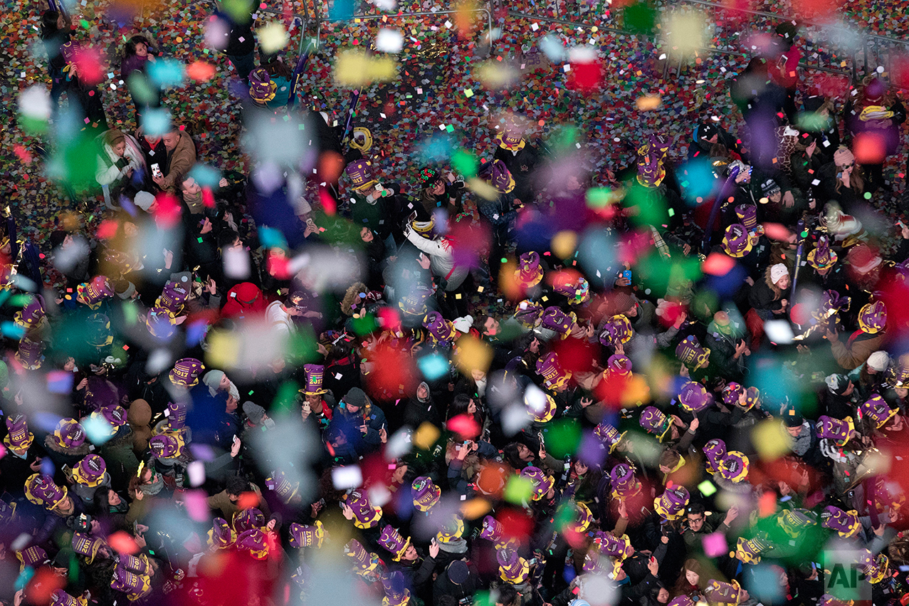  Revelers celebrate the new year as confetti flies over New York's Times Square as seen from the Marriott Marquis, Sunday, Jan. 1, 2017. (AP Photo/Mary Altaffer) 