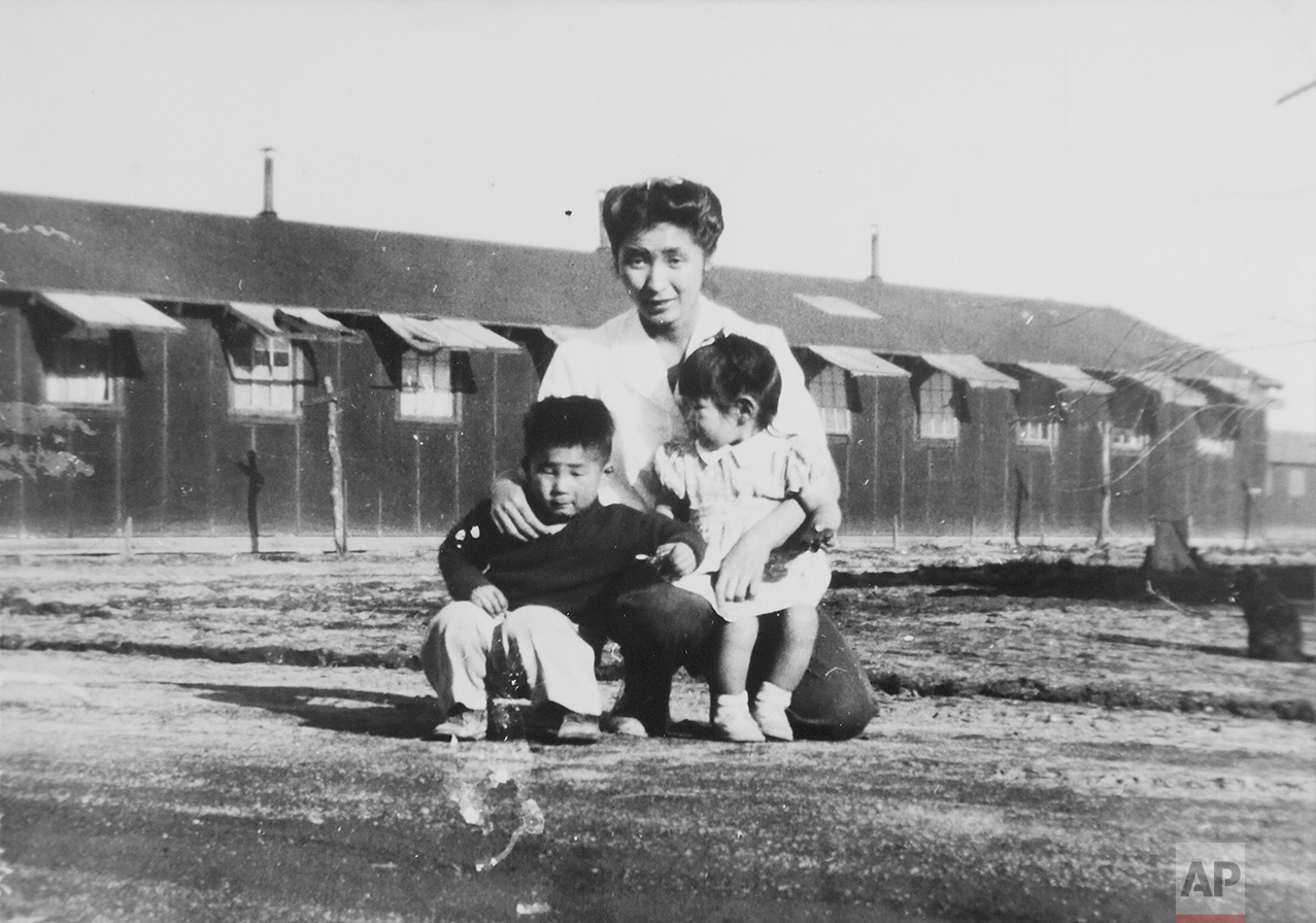 This 1945 photo provided by the family shows Shizuko Ina, with her son, Kiyoshi, left, and daughter, Satsuki, in a prison camp in Tule Lake, Calif. This photo was made by a family friend who was a soldier at the time, since cameras were considered contraband at the camp. Satsuki was born at the camp. (Courtesy of the Ina family via AP)