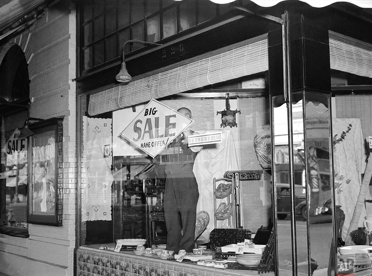 Bargains, with articles marked down as much as 40 percent, were on everywhere in Los Angeles' "Little Tokyo", March 5, 1942, as its Japanese residents prepare to leave following the issuance of orders for the evacuation of enemy aliens and American-born Japanese from specified combat zones along the Pacific coast. T. Horiuchi, proprietor of one of the largest Asian art stores in the district, posts a sale sign in his window. Alongside is a sign declaring, "We are 100 percent for the United States." (AP Photo)