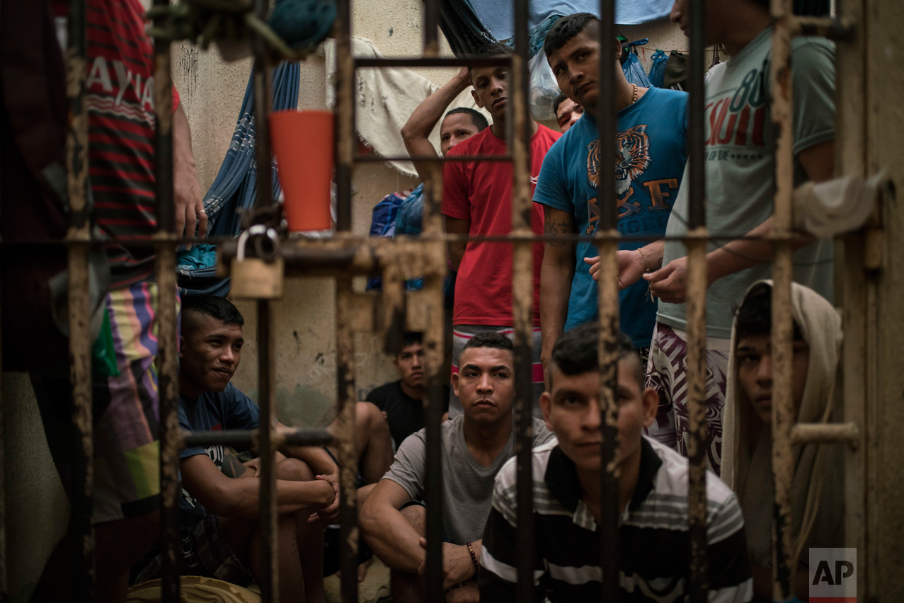 In this Feb. 6, 2017 photo, detainees crowd a holding cell at a police station near Manaus, Brazil. The beginning of the chain that feeds Brazilian gangs are improvised cells at police stations, where 10 percent of Brazil's more than 600,000 inmates await trial. (AP Photo/Felipe Dana)