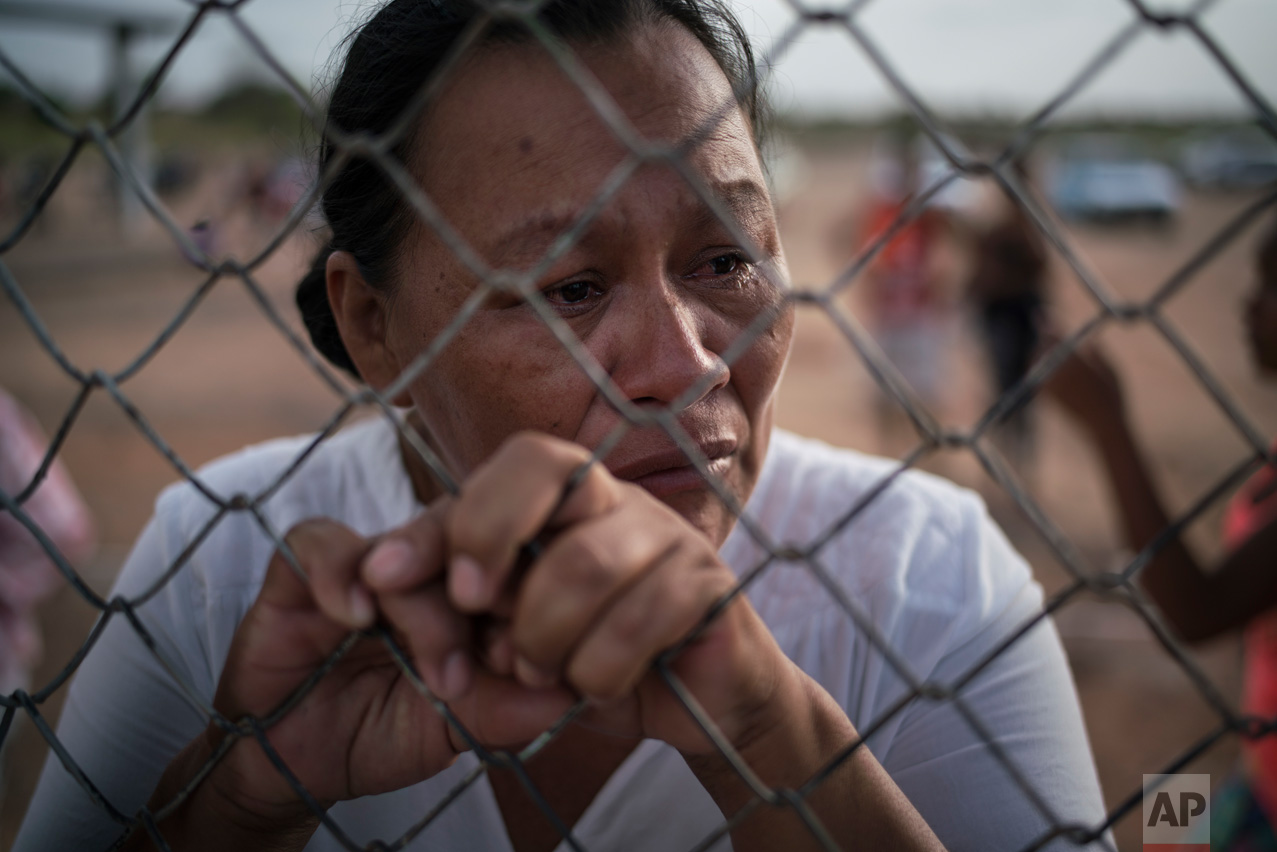 In this Feb. 2, 2017 photo, Katia Reis waits to deliver food to her son who's serving time at the Monte Cristo agricultural penitentiary in Boa Vista, Brazil. In this far northern city, at least 33 inmates were killed in a prison riot in January. (AP Photo/Felipe Dana)