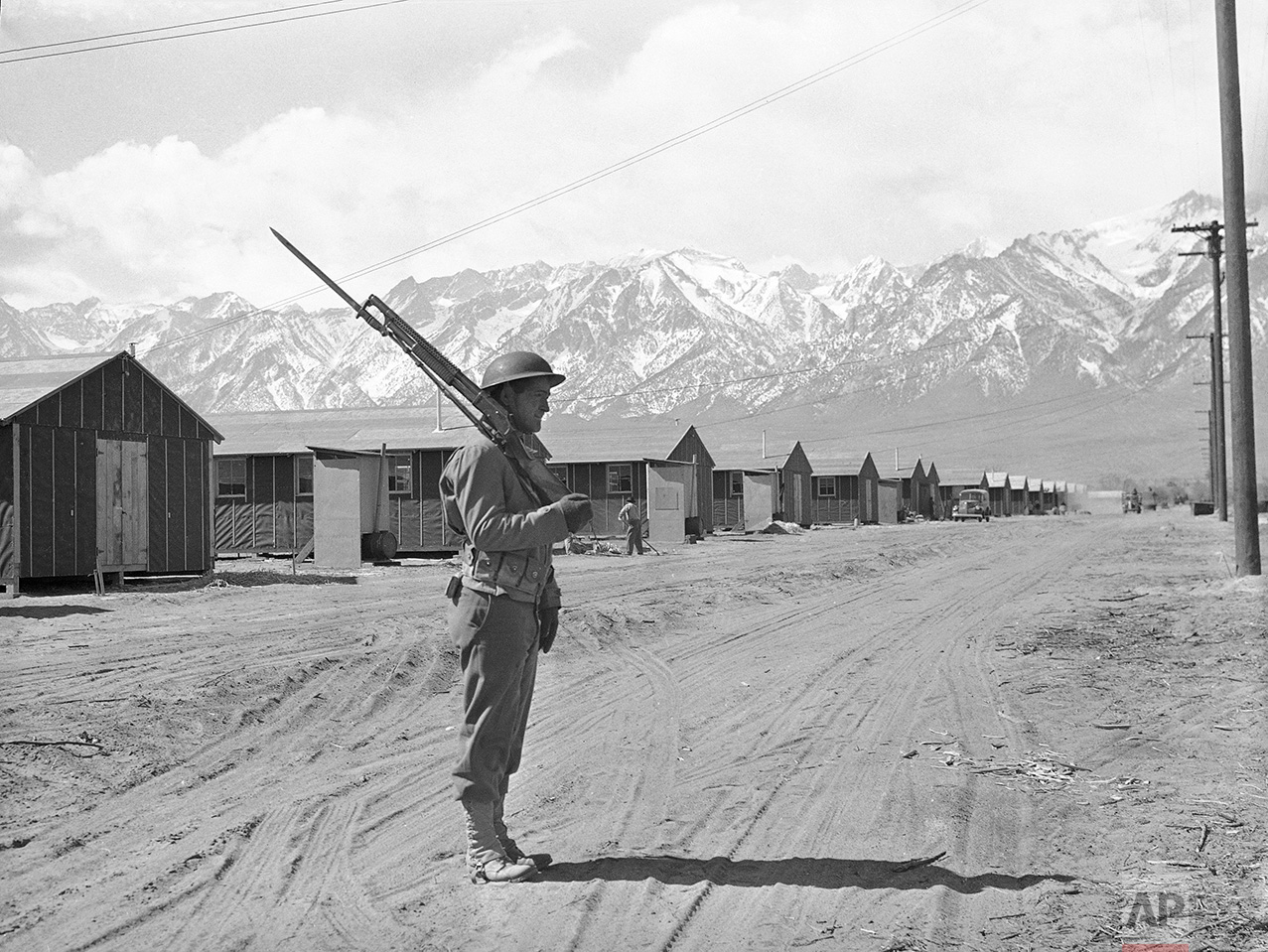 An American soldier guards a Japanese internment camp at Manzanar, Calif., May 23, 1943. (AP Photo)