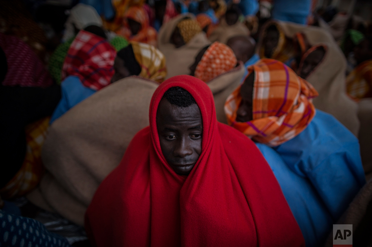 Refugees and migrants rest aboard the Golfo Azurro, the Spanish NGO Proactiva Open Arms rescue ship after being rescued off the Libyan coast, early in the morning on Thursday Feb. 23, 2017. (AP Photo/Santi Palacios)