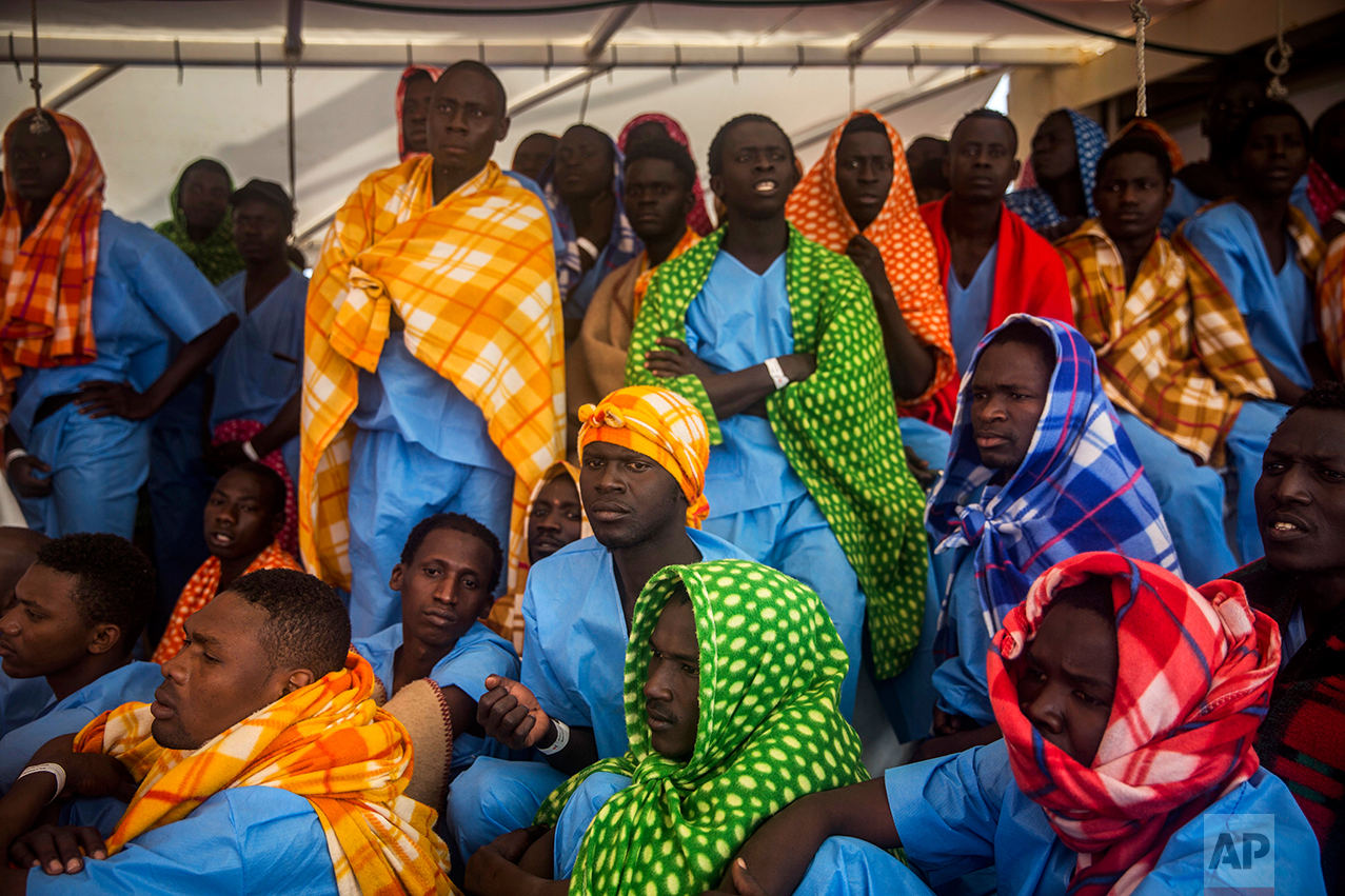 Refugees and migrants rest aboard Golfo Azurro, the Spanish NGO Proactiva Open Arms rescue ship, after being rescued from a boat out of control at 25 miles north of Sabratha, off the Libyan coast, early in the morning on Thursday Feb. 23, 2017. (AP Photo/Santi Palacios)