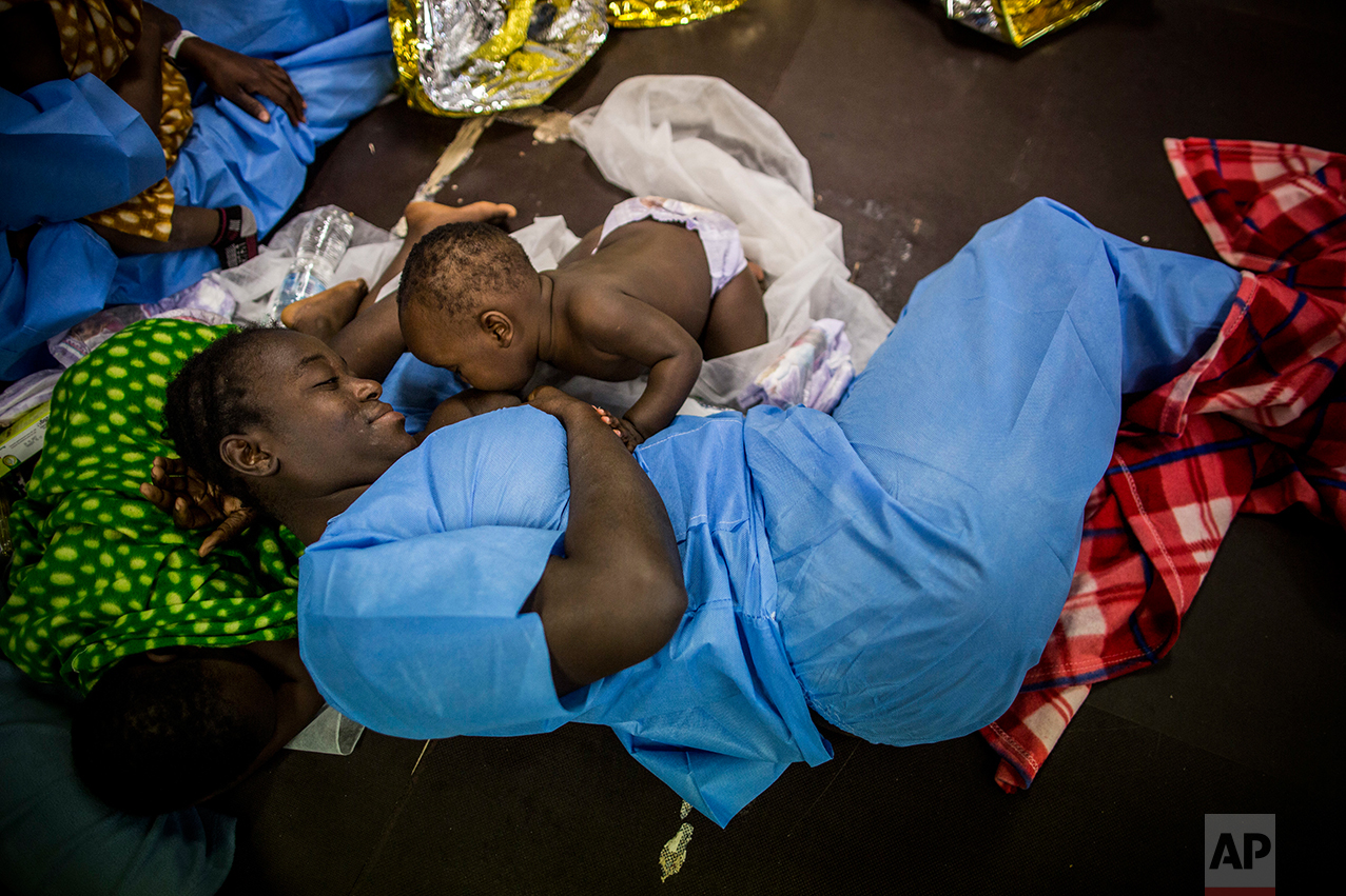 A woman from Ivory Coast suckles her baby aboard Golfo Azurro, the Spanish NGO Proactiva Open Arms rescue ship, after being rescued from a boat out of control at 25 miles north of Sabratha, off the Libyan coast, early in the morning on Thursday Feb. 23, 2017. (AP Photo/Santi Palacios)