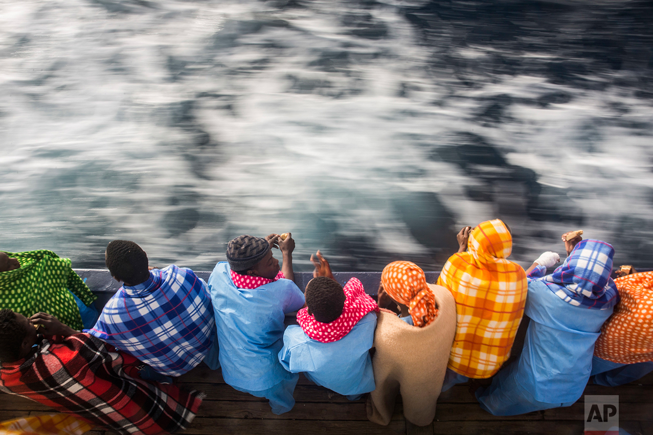 African refugees and migrants, mostly from Sudan and Senegal, look at the sea aboard Golfo Azurro, the Spanish NGO Proactiva Open Arms rescue ship, after being rescued from a boat out of control at 25 miles north of Sabratha, off the Libyan coast, early in the morning on Thursday Feb. 23, 2017. (AP Photo/Santi Palacios)