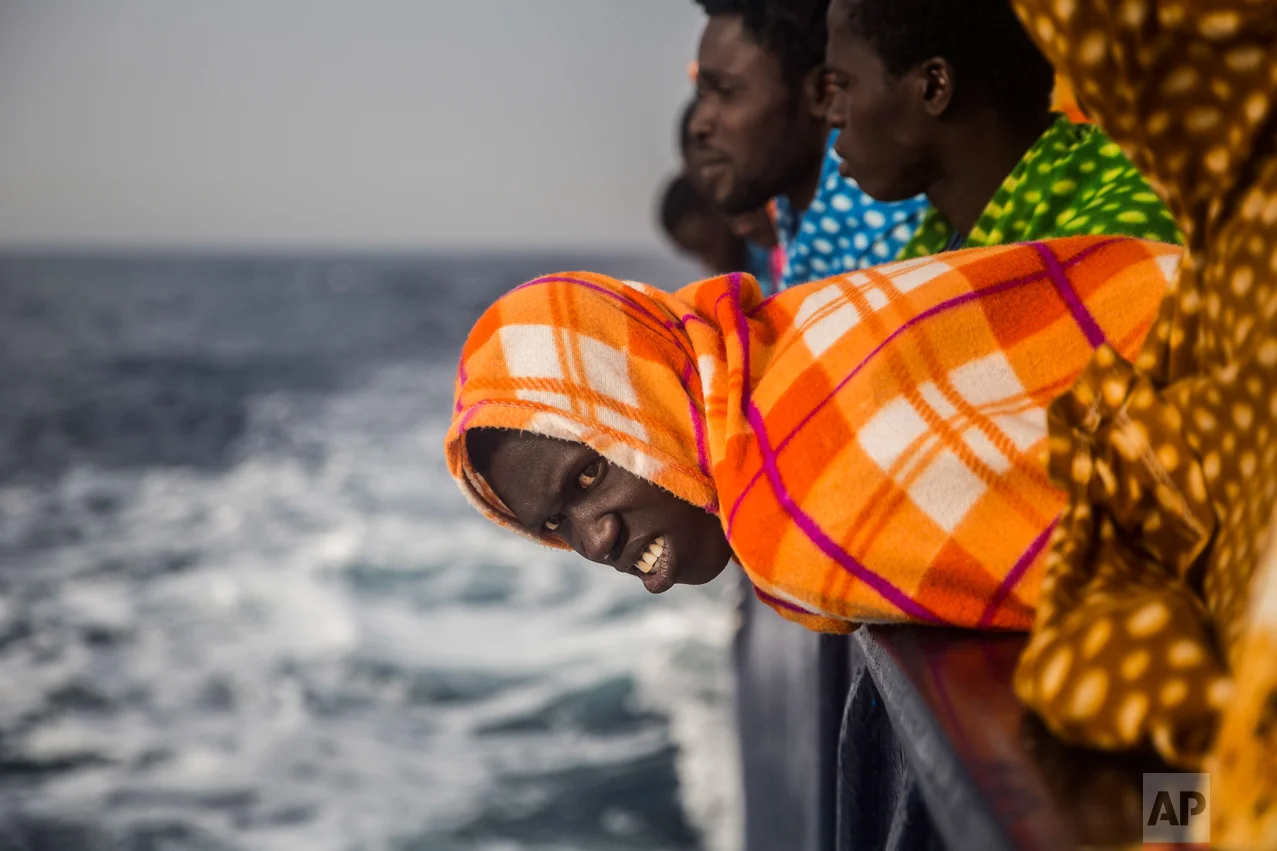 African refugees and migrants, mostly from Sudan and Senegal, look at the sea aboard the Golfo Azurro, a rescue ship of the Spanish Proactiva Open Arms NGO, after being rescued from a boat out of control at 25 miles north of Sabratha, off the Libyan coast, early in the morning on Thursday Feb. 23, 2016. (AP Photo/Santi Palacios)