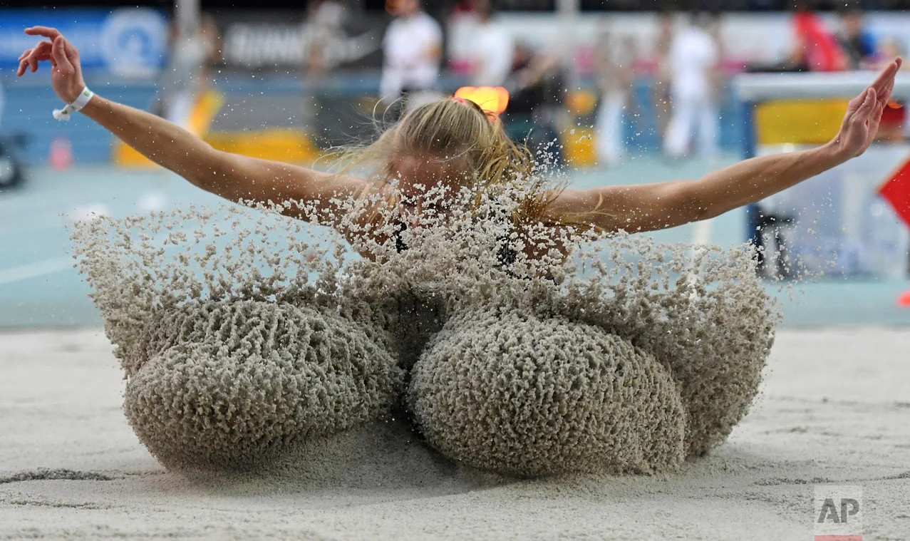 Luisa Bodem kicks up sand as she competes in the women's long jump event at the German indoor athletics in Leipzig, Germany, on Sunday, Feb. 19, 2017. (Hendrik Schmidt/dpa via AP)