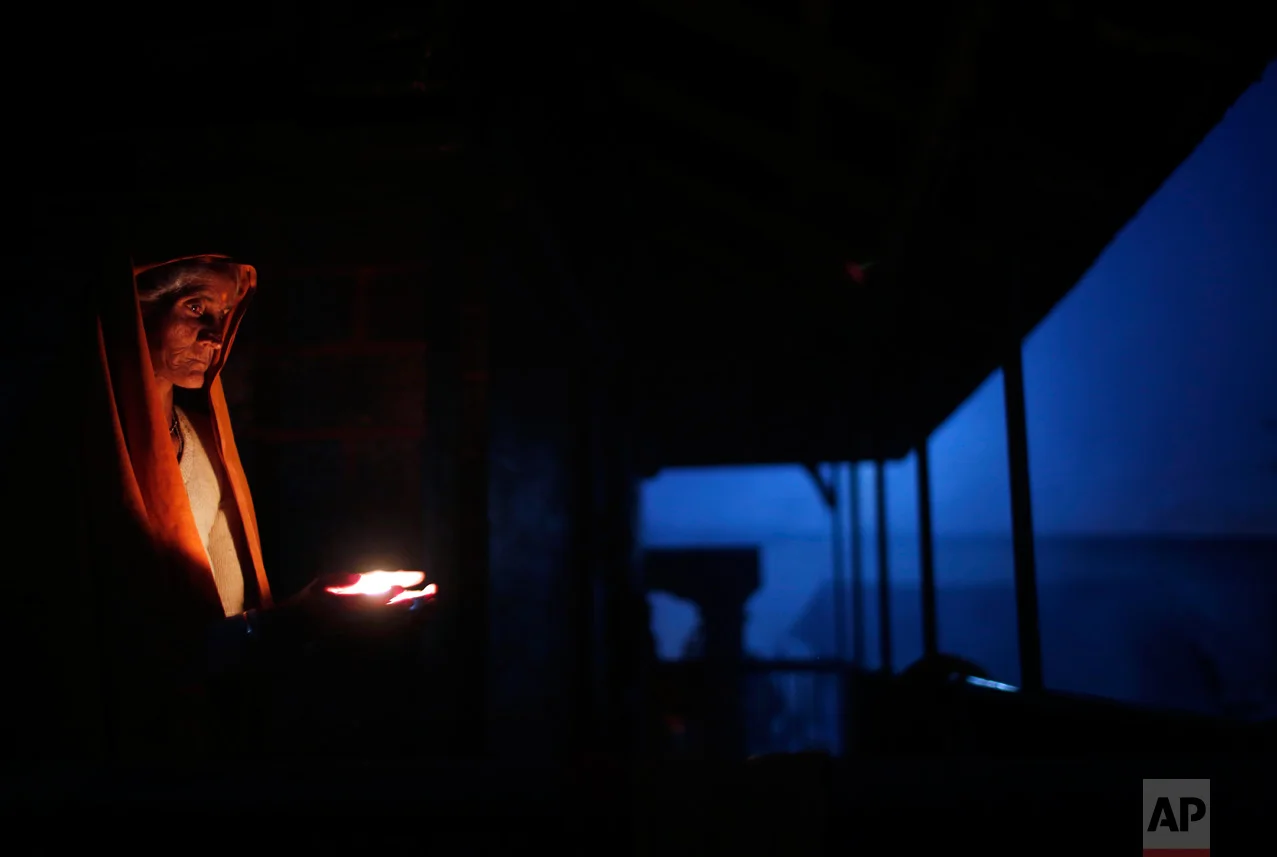 A Hindu holy woman lights an oil lamp during Shivaratri festival in Kathmandu, Nepal, Friday, Feb. 24, 2017. Shivaratri, or the night of Shiva, is dedicated to the worship of Lord Shiva, the Hindu god of death and destruction. (AP Photo/Niranjan Shrestha)