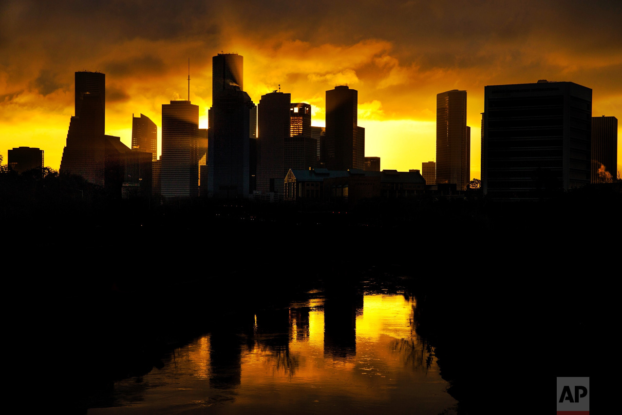 Sunlight streams between skyscrapers as the sun rises behind downtown Houston on Tuesday, Feb. 21, 2017. (Michael Ciaglo/Houston Chronicle via AP)