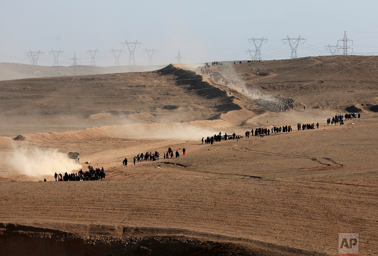  Displaced Iraqis flee their homes due to fighting between Iraqi security forces and Islamic State militants, on the western side of Mosul, Iraq, Saturday, Feb. 25. 2017. (AP Photo/ Khalid Mohammed) 