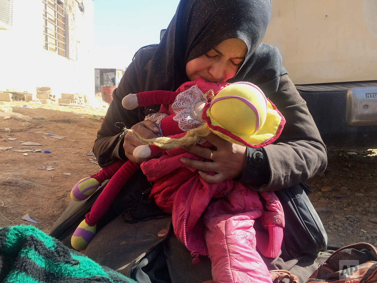  Safana Hamad, a displaced Iraqi mother, holds her daughter  Manar's doll and jacket while mourning over her body, after the four-year-old was killed in an Islamic State mortar attack while trying to flee fighting between Iraqi security forces and Is