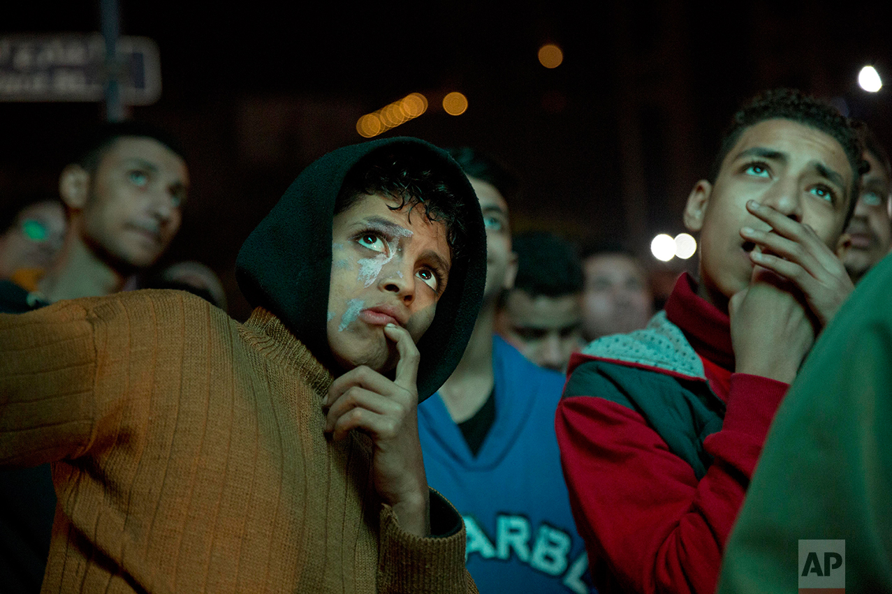  People watch Egypt and Cameroon play the final match in the African Cup of Nations on a large outdoor screen, in the Mohandeseen neighborhood of Cairo, Egypt, Sunday, Feb. 5, 2017. Cameron won 2-1, in the Gabonese capital, Libreville. (AP Photo/Thom