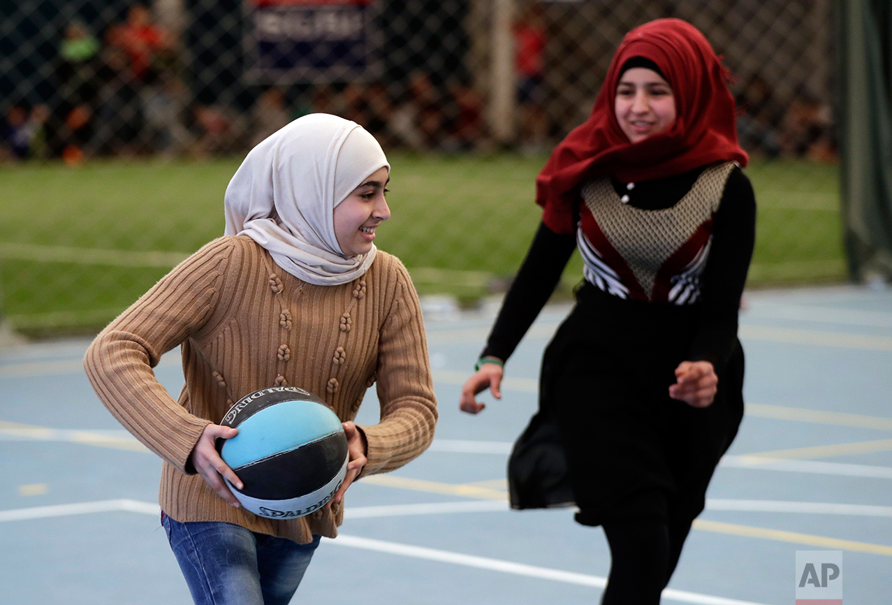  Syrian refugee girls play a basketball game at a private sports club, southern Beirut, Lebanon on Sunday, Feb. 19, 2017. (AP Photo/Hussein Malla) 