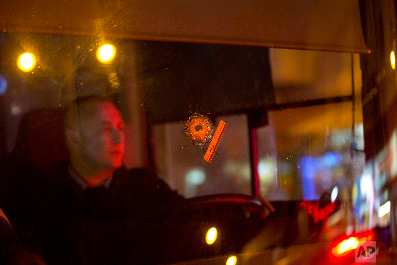  A bullet hole is seen on the windshield of a bus at the scene of a shooting attack in Petah Tikva, Israel, Thursday, Feb. 9, 2017. (AP Photo/Oded Balilty) 