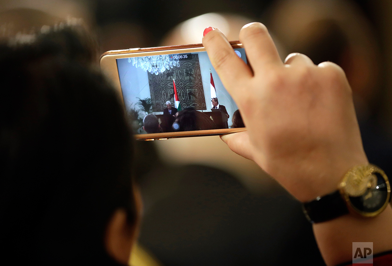  A Lebanese journalist recording through her mobile phone the speeches of Palestinian president Mahmoud Abbas and his Lebanese counterpart Michel Aoun, at the presidential palace, in Baabda east Beirut, Lebanon, Thursday, Feb. 23, 2017. Abbas is in B