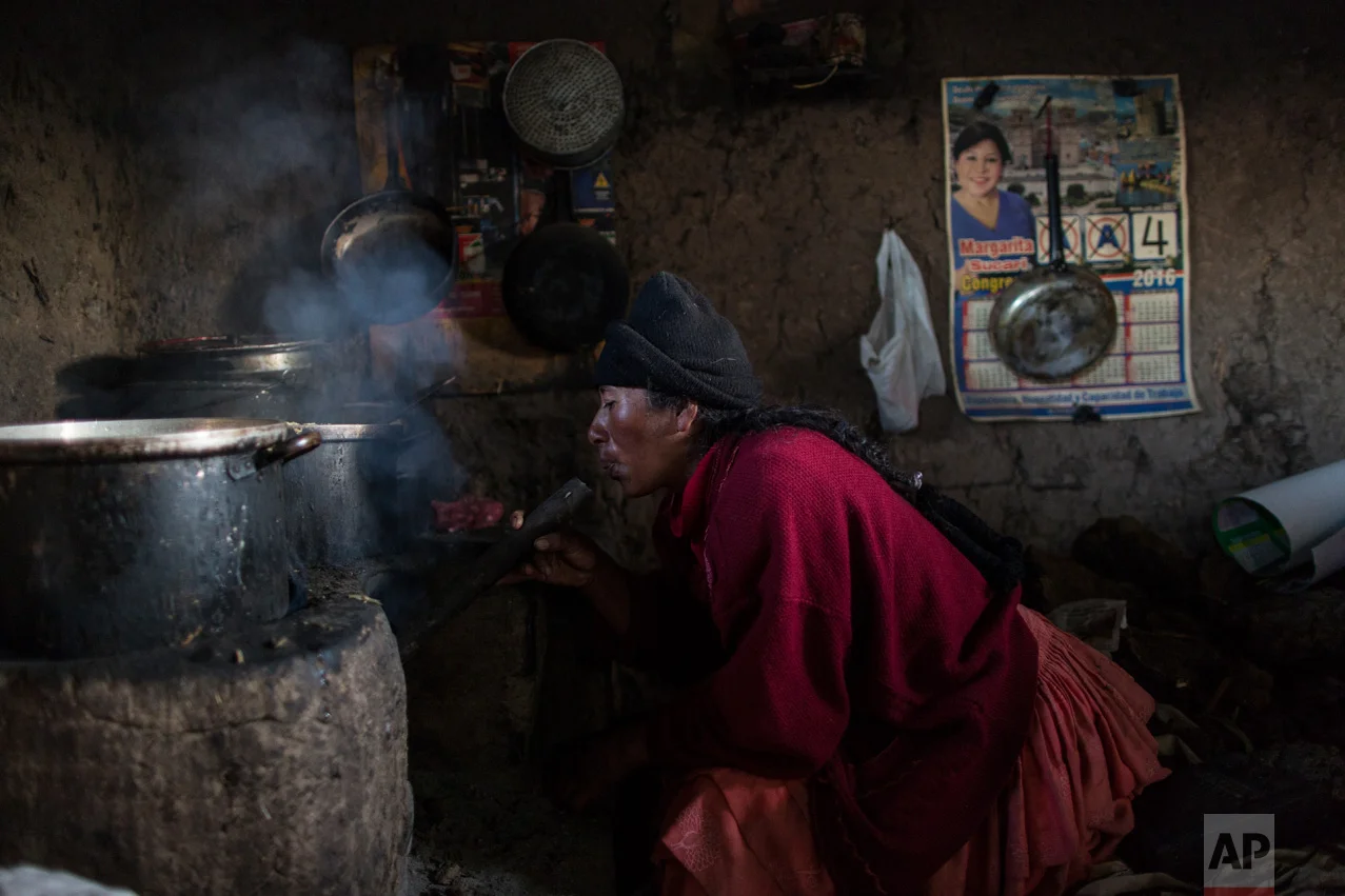 In this Feb. 4, 2017 photo, Lilian Avila Diaz lights her firewood stove to cook lunch for her family in Coata, a small village on the shore of Lake Titicaca, in the Puno region of Peru. The amount of mercury consumed by Titicaca residents is “unacceptable,” according to Dr. Jane M. Hightower, who specializes in internal medicine at the California Pacific Medical Center in San Francisco and author of the book “Diagnosis: Mercury: Money, Politics & Poison,” after reviewing a 2014 study on fish caught from Lake Titicaca. (AP Photo/Rodrigo Abd)