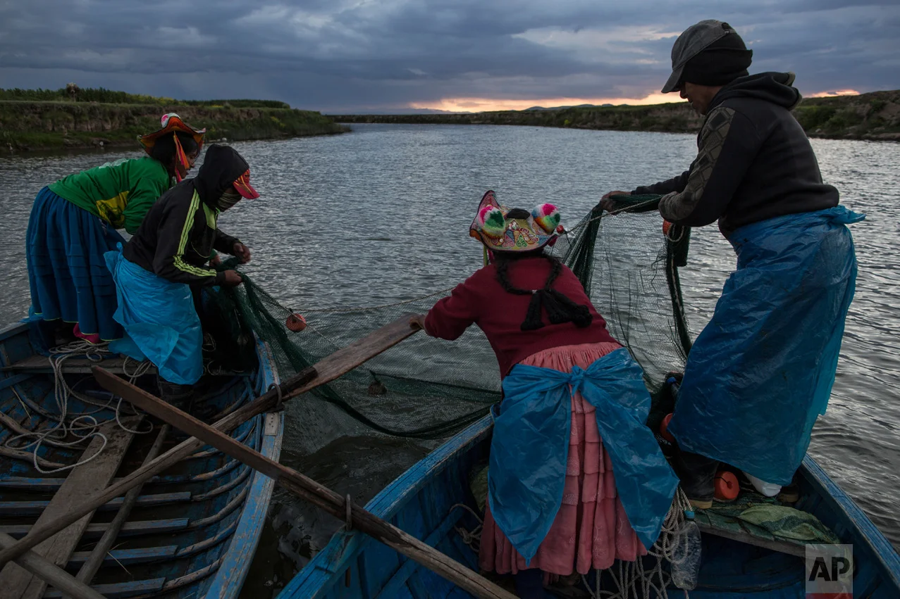 In this Feb. 3, 2017 photo, the Avila family fishes on the Coata River, which flows into Lake Titicaca, in the Puno region of Peru. Untreated sewage water drains from two dozen nearby cities, and illegal gold mines high in the Andes dump up to 15 tons of mercury a year into the river leading to the lake. (AP Photo/Rodrigo Abd)