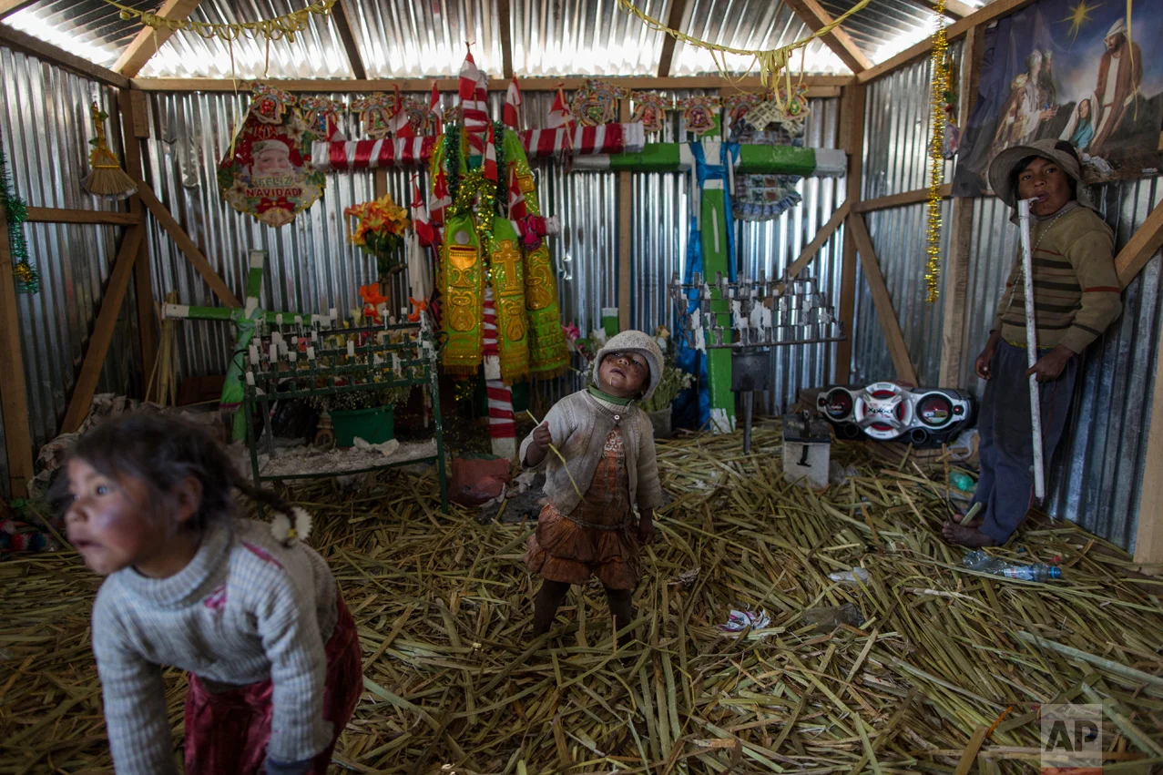 In this Feb. 2, 2017 photo, children play inside a church in Kapi Cruz Grande, a community on the shores of Lake Titicaca in the Puno region of Peru. Many living on the 4,000-meter (13,100-feet) high plain surrounding the lake contaminated with toxic levels of lead and mercury feel government leaders have neglected them. (AP Photo/Rodrigo Abd)
